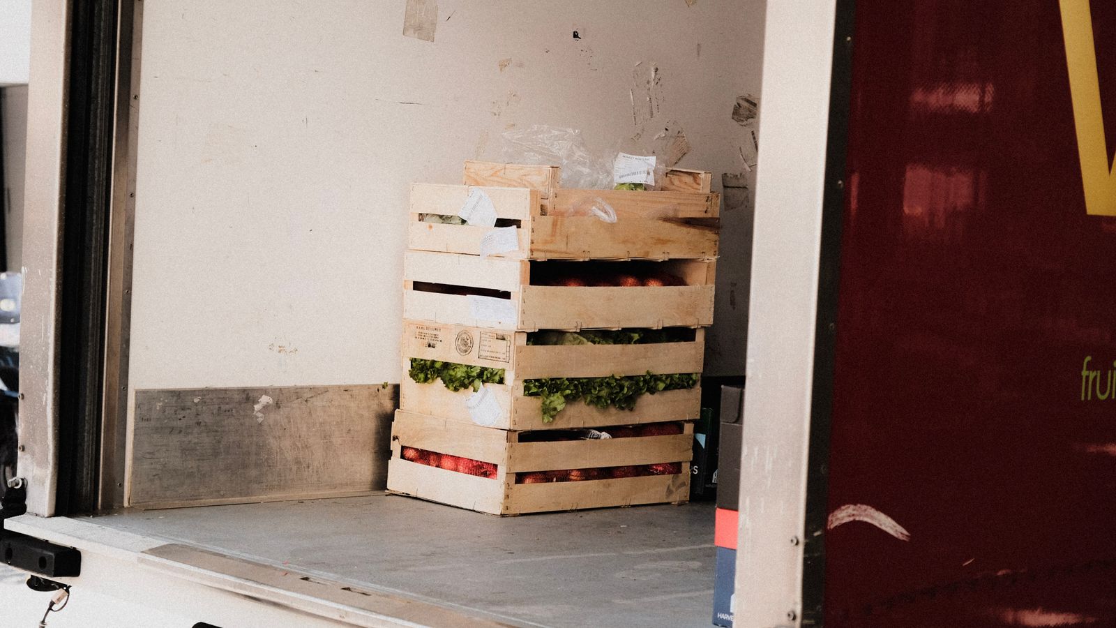Crates of fresh produce inside a refrigerated delivery vehicle